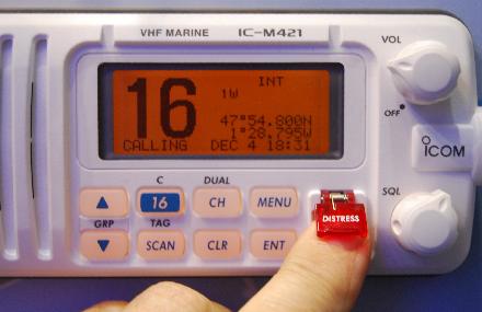 Finger pressing marine radio distress button