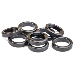 Pile of dark metallic rings on white background