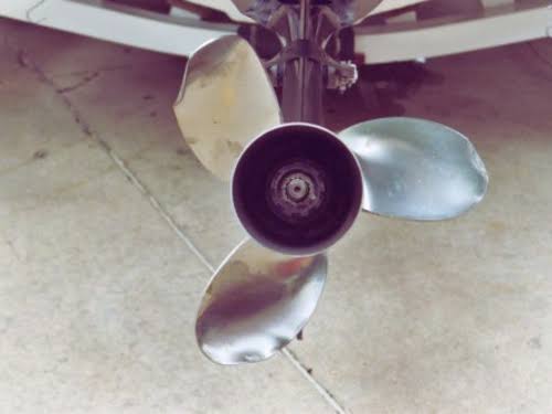 Three-blade boat propeller viewed from beneath a vessel